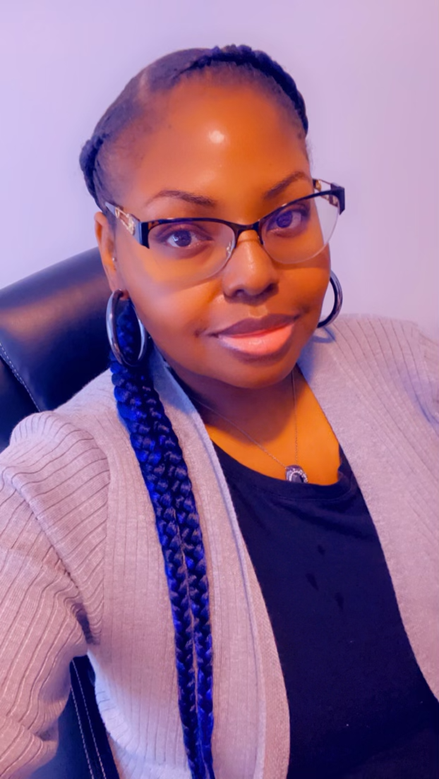 A'Nita 'Ace' Evans, product designer, smiling in a portrait photo